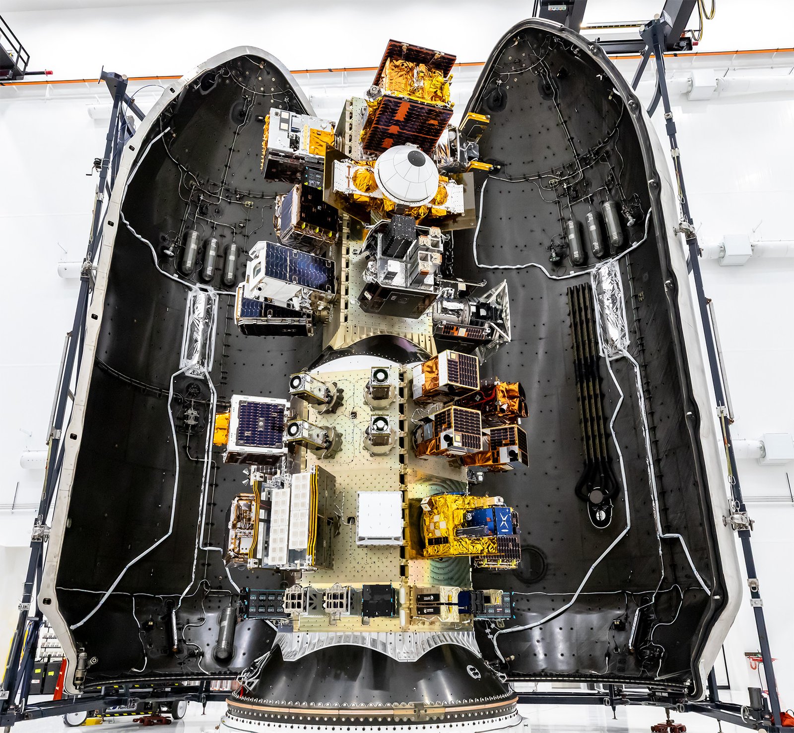 Multiple spacecraft mounted inside the Transporter-18 payload fairing ahead of launch.